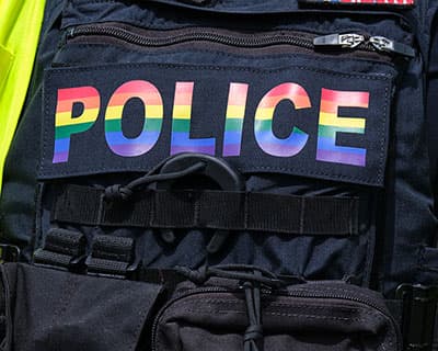 A police vest with the police logo in rainbow